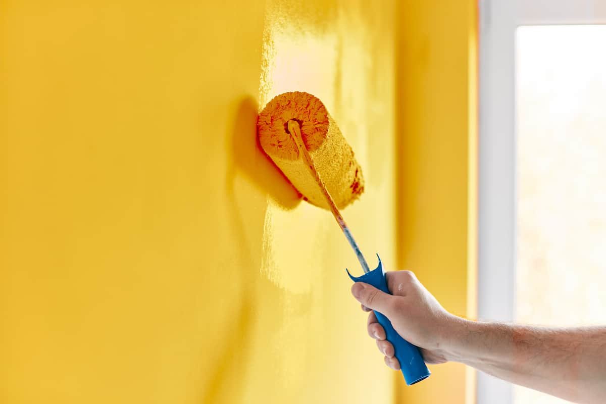Professional painter with paint roller in Midland TX